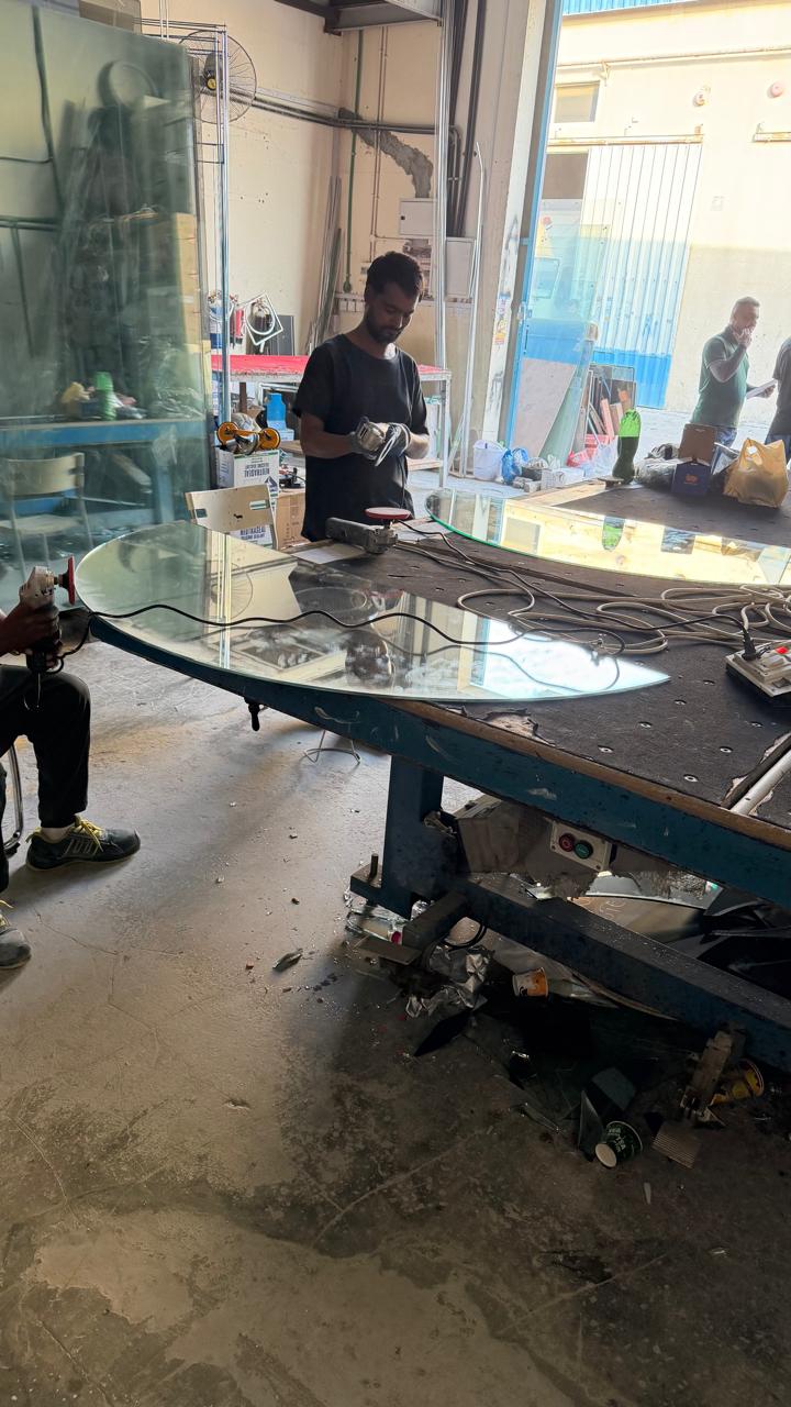 Technicians edging and finishing a panel in a fabrication workshop